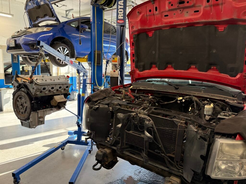 Engine being removed from a Chevrolet Silverado at Chuck’s Auto Repair – Shoreline.
