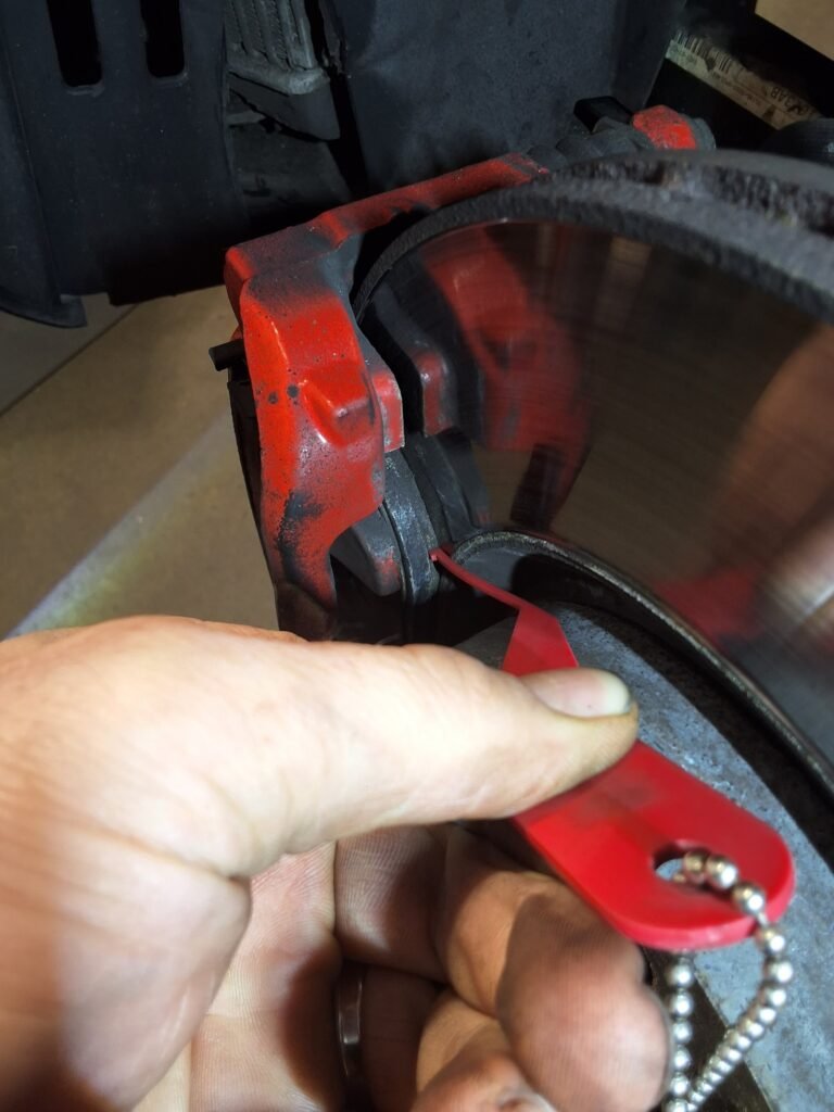 Brake pad thickness being measured during a vehicle inspection.
