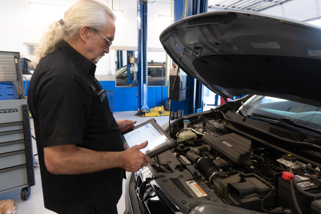 Technician diagnosing an Acura TSX with a rough running engine at Chuck’s Auto Repair Shoreline.