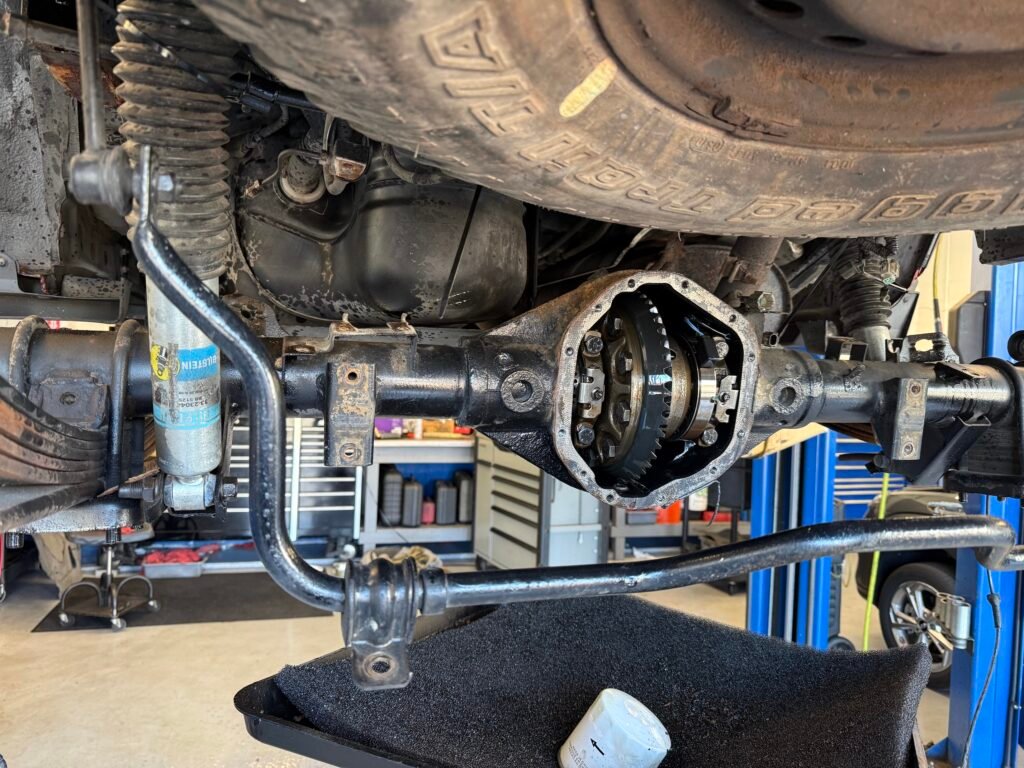Original rear differential exposed on a Nissan Xterra before replacement at Chuck’s Auto Repair Shoreline.